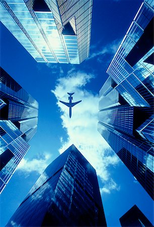 simsearch:700-01223637,k - Looking Up at Airplane Flying Over Office Towers Stock Photo - Rights-Managed, Code: 700-00025416