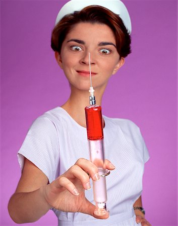 Nurse Holding Large Syringe Foto de stock - Con derechos protegidos, Código: 700-00025587