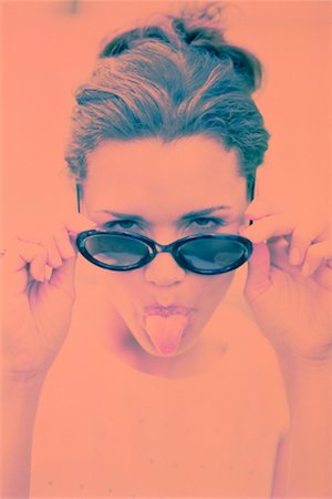 simsearch:700-03685912,k - Portrait of Woman Sticking Out Tongue Stock Photo - Rights-Managed, Code: 700-00028782