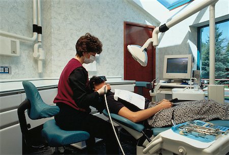 dentist with patient in exam room - Dental Cleaning Stock Photo - Rights-Managed, Code: 700-00021255