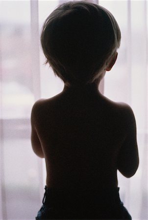 Silhouette of Little Boy Looking Out of Window Stock Photo - Rights-Managed, Code: 700-00022964