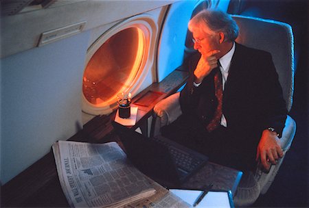 Mature Businessman Looking Out of Airplane Window Stock Photo - Rights-Managed, Code: 700-00035205