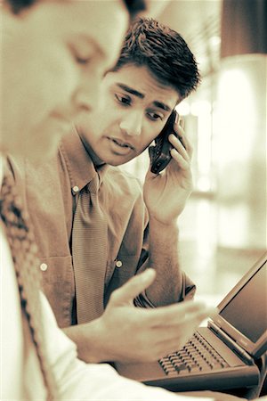 simsearch:700-00163379,k - Businessman Using Cell Phone and Laptop Computer Stock Photo - Rights-Managed, Code: 700-00035281