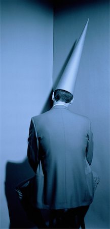 simsearch:700-00078438,k - Businessman Wearing Dunce Cap Sitting in Corner Stock Photo - Rights-Managed, Code: 700-00035439