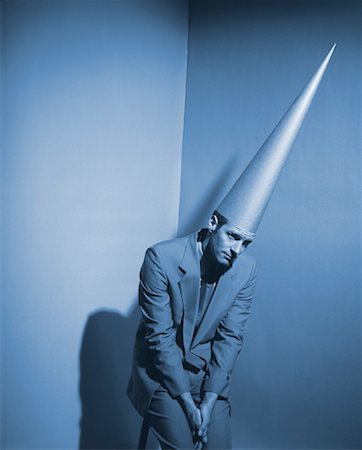 simsearch:700-00078438,k - Businessman Wearing Dunce Cap Sitting in Corner Stock Photo - Rights-Managed, Code: 700-00036435
