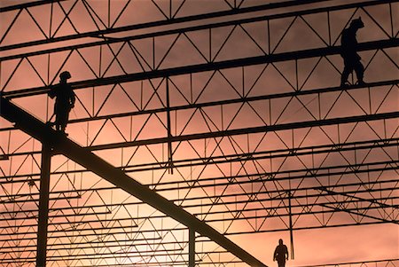 simsearch:700-00030097,k - Silhouette of Workers Walking on Steel Supports at Sunset Stock Photo - Rights-Managed, Code: 700-00030315