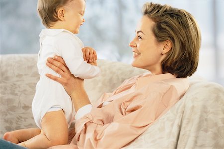 simsearch:700-00080994,k - Mother Holding Baby on Sofa Stock Photo - Rights-Managed, Code: 700-00033004