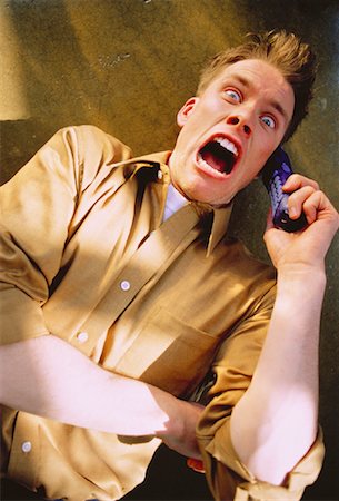Frightened Man Using Cordless Telephone Stock Photo - Rights-Managed, Code: 700-00045110