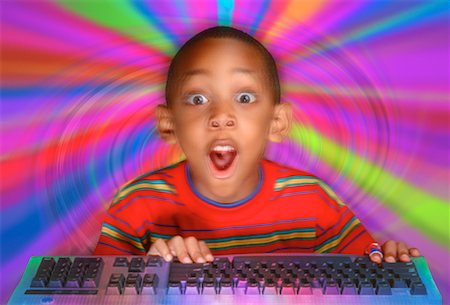 suprised african american kid - Boy at Computer Keyboard with Abstract Background Stock Photo - Rights-Managed, Code: 700-00045578