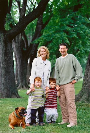 Portrait of Family in Park With Dog Stock Photo - Rights-Managed, Code: 700-00048019