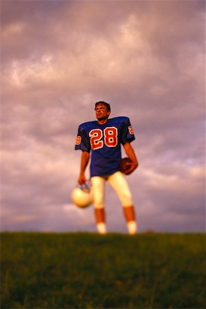 simsearch:700-03698187,k - Portrait of Football Player Holding Ball and Helmet Outdoors Stock Photo - Rights-Managed, Code: 700-00048632