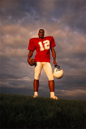 simsearch:700-00048630,k - Portrait of Football Player Holding Ball and Helmet Outdoors Stock Photo - Rights-Managed, Code: 700-00048633