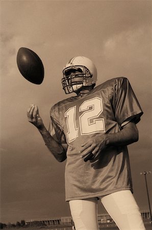 peter griffith - Football Player Tossing Ball in Air Stock Photo - Rights-Managed, Code: 700-00048642