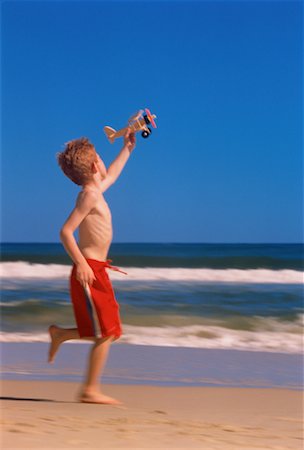 Boy in Swimwear, Running on Beach With Toy Airplane Surfers Paradise, Australia Stock Photo - Rights-Managed, Code: 700-00040099