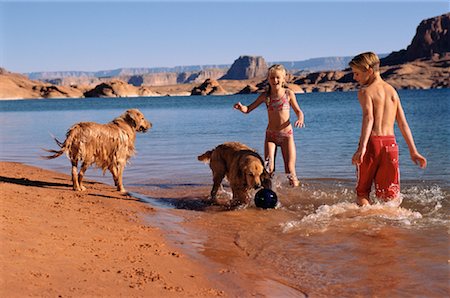 Boy and Girl in Swimwear on Beach With Dogs Lake Powell, Arizona, USA Stock Photo - Rights-Managed, Code: 700-00041560