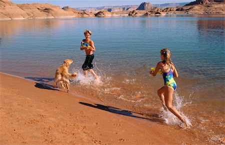 Boy and Girl in Swimwear on Beach With Dogs Lake Powell, Arizona, USA Stock Photo - Rights-Managed, Code: 700-00041561