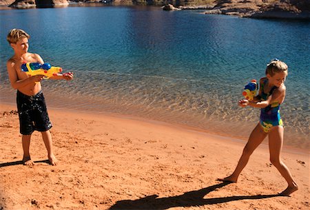 simsearch:700-01183991,k - Boy and Girl in Swimwear, Playing With Water Guns on Beach Lake Powell, Arizona, USA Stock Photo - Rights-Managed, Code: 700-00041562