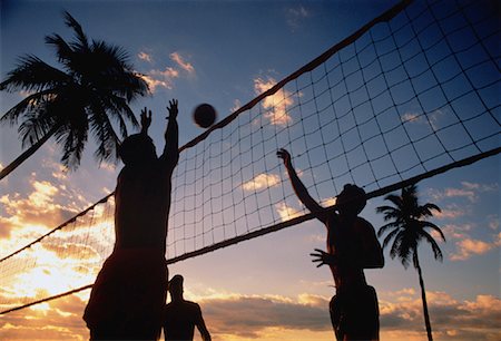 simsearch:632-01155154,k - Silhouette of Men Playing Beach Volleyball at Sunset Stock Photo - Rights-Managed, Code: 700-00042354