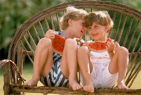 pictures of a little girl whispering - Children Eating Watermelon Outdoors Stock Photo - Rights-Managed, Code: 700-00042383