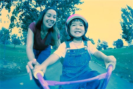 simsearch:700-03067843,k - Mother Helping Daughter Learn to Ride Bicycle in Park Stock Photo - Rights-Managed, Code: 700-00054165