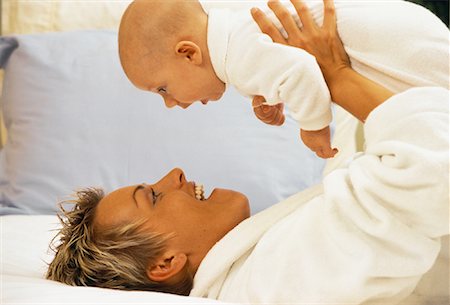simsearch:700-00080994,k - Mother Lying on Bed, Holding Baby Face to Face Stock Photo - Rights-Managed, Code: 700-00054377