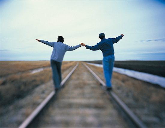 holding hands train tracks