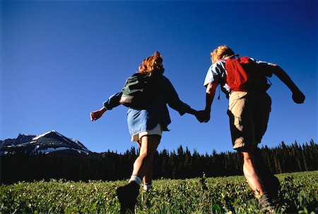 simsearch:700-00554641,k - Back View of Couple Hiking Through Field Stock Photo - Rights-Managed, Code: 700-00055035