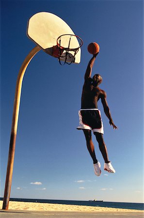 simsearch:700-00060777,k - Man Jumping to Slam Dunk Basketball Stock Photo - Rights-Managed, Code: 700-00055266