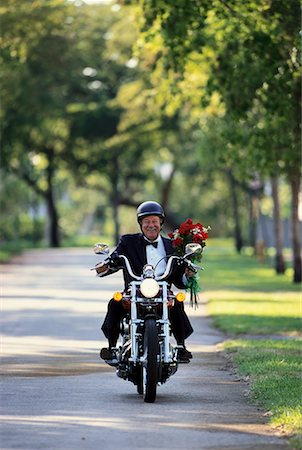 simsearch:700-00189342,k - Mature Man Riding Motorcycle Carrying Bouquet of Flowers Stock Photo - Rights-Managed, Code: 700-00055368
