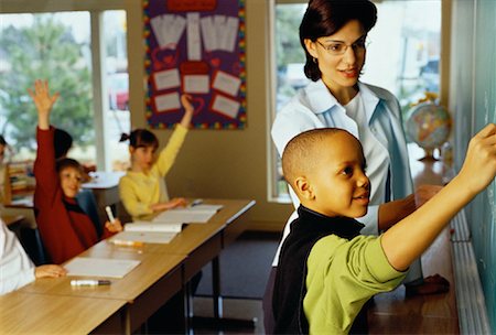 simsearch:700-01954522,k - Boy Standing Next to Teacher Writing on Blackboard Stock Photo - Rights-Managed, Code: 700-00055460
