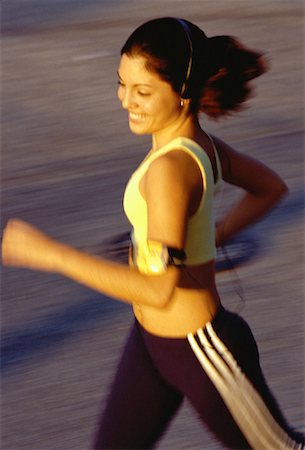 Teenage Girl Using Personal Stereo while Jogging Stock Photo - Rights-Managed, Code: 700-00055735