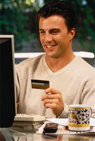 simsearch:700-00478040,k - Man Sitting at Computer, Holding Credit Card Foto de stock - Con derechos protegidos, Código: 700-00055746