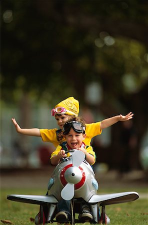 Two Children Playing with Toy Airplane Outdoors Stock Photo - Rights-Managed, Code: 700-00055800