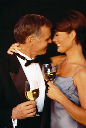 simsearch:700-01185414,k - Mature Couple Wearing Formal Wear Holding Wine Glasses, Embracing Stock Photo - Rights-Managed, Code: 700-00055924
