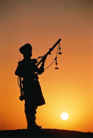 simsearch:855-03021954,k - Silhouette of Man with Musical Instrument at Sunset Rajsalmer, India Stock Photo - Rights-Managed, Code: 700-00057657