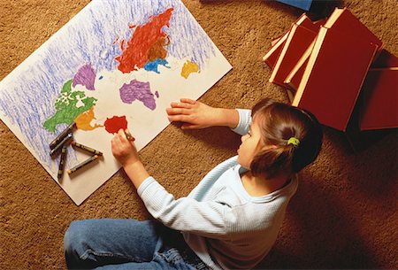 Overhead View of Girl Sitting on Floor Coloring World Map Stock Photo - Rights-Managed, Code: 700-00057719