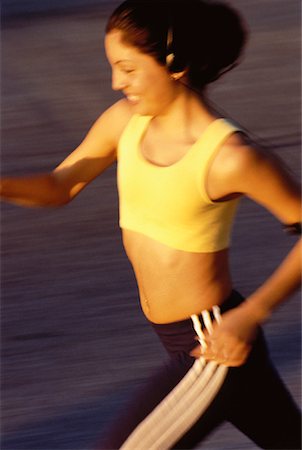 Teenage Girl Using Personal Stereo while Jogging Stock Photo - Rights-Managed, Code: 700-00057733