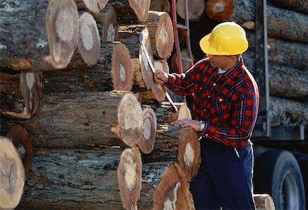 Man Measuring Cut and Stacked Lumber, Ontario, Canada Stock Photo - Rights-Managed, Code: 700-00058873