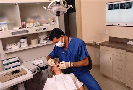 dentist with patient in exam room - Male Dentist and Female Patient Stock Photo - Rights-Managed, Code: 700-00050222
