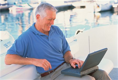 peter griffith - Mature Man Using Laptop Computer On Boat Stock Photo - Rights-Managed, Code: 700-00051210