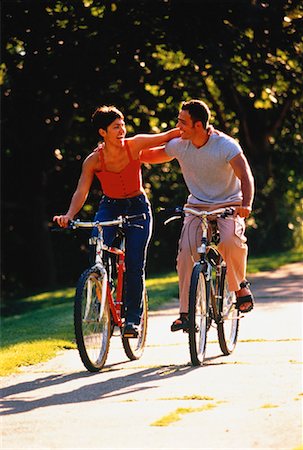 simsearch:700-00549929,k - Couple Riding Bicycles Side by Side on Pathway Stock Photo - Rights-Managed, Code: 700-00051472