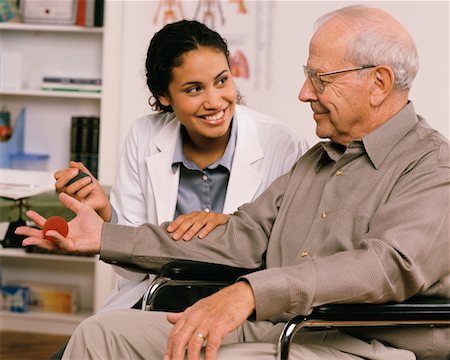 simsearch:700-03501276,k - Female Physiotherapist Talking to Mature Male Patient in Wheelchair Stock Photo - Rights-Managed, Code: 700-00051657
