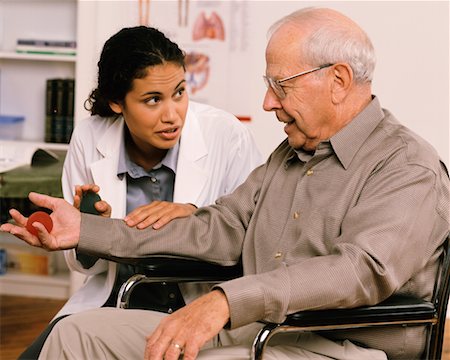 simsearch:700-00616589,k - Female Physiotherapist Talking to Mature Male Patient in Wheelchair Stock Photo - Rights-Managed, Code: 700-00051658