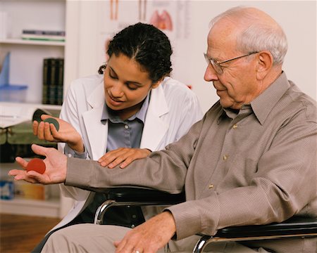simsearch:700-03501276,k - Female Physiotherapist Talking to Mature Male Patient in Wheelchair Stock Photo - Rights-Managed, Code: 700-00051659