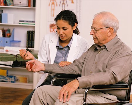 simsearch:700-03501276,k - Female Physiotherapist Talking to Mature Male Patient in Wheelchair Stock Photo - Rights-Managed, Code: 700-00051660