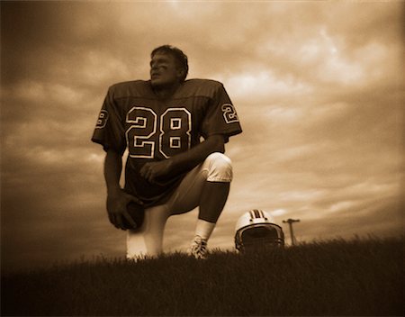 simsearch:700-00048630,k - Football Player Kneeling on Field Holding Football Stock Photo - Rights-Managed, Code: 700-00053088