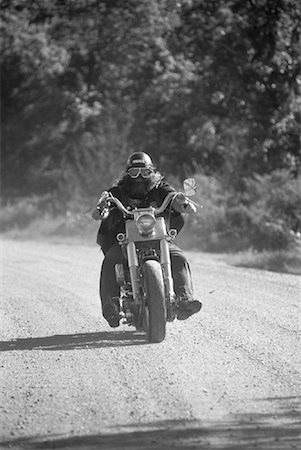 Biker Riding Motorcycle on Gravel Road, Ontario, Canada Stock Photo - Rights-Managed, Code: 700-00053298