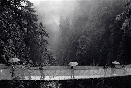 person crossing a gorge - Capilano Suspension Bridge in Rain, Vancouver, British Columbia Canada Stock Photo - Rights-Managed, Code: 700-00053902