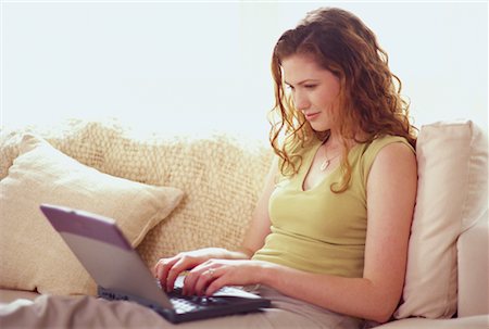 simsearch:700-00083403,k - Young Woman Sitting on Sofa Using Laptop Computer Stock Photo - Rights-Managed, Code: 700-00064389