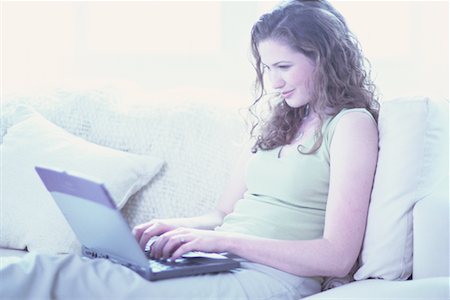 simsearch:700-00083403,k - Young Woman Sitting on Sofa Using Laptop Computer Stock Photo - Rights-Managed, Code: 700-00064390